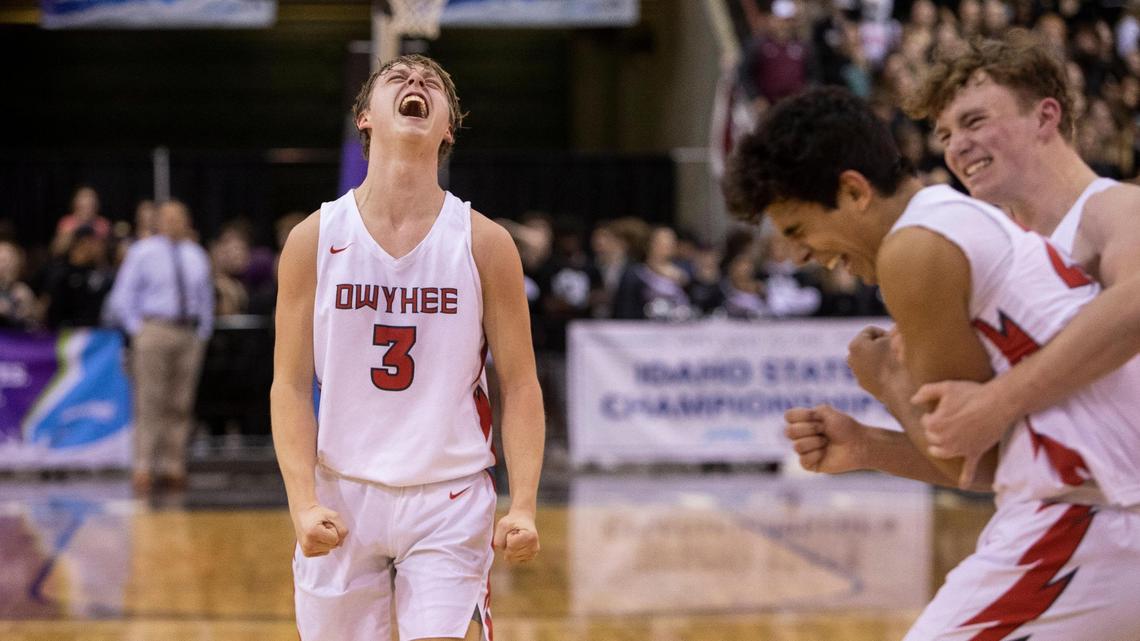 Owyhee’s Preston Sherburne, at left, and Titus Bailey and Barrett Fernandez, at right, celebrate the 5A boys basketball state championship title last year at the Ford Idaho Center.