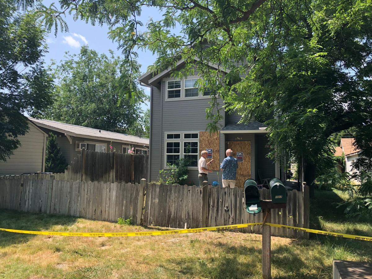 Caution tape surrounds a home on the 1500 block of South Leadville Avenue, where an early morning fire killed one woman and two children on July 8, 2019.
