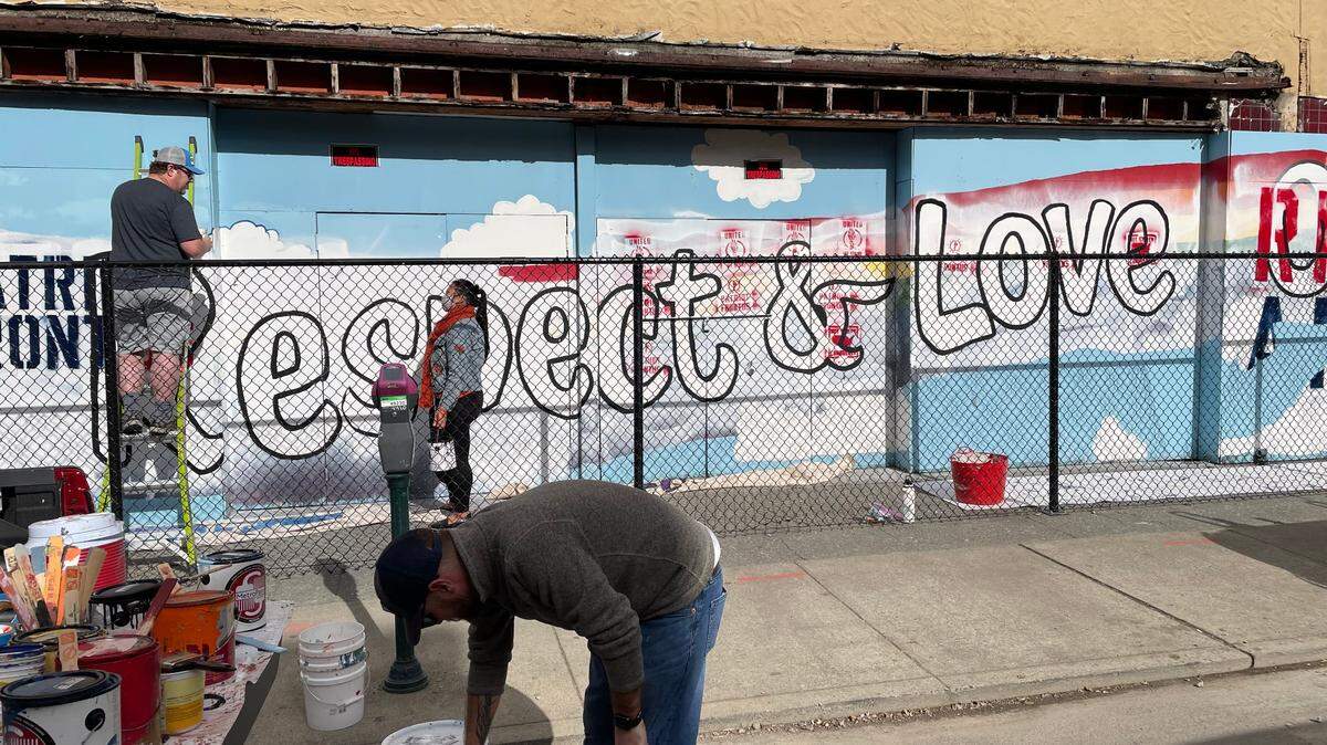 Members of Unity in the Community restore the vandalized pride mural on Oct. 16, 2021.