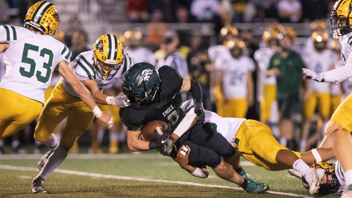 Eagle running back Deegan Martinho is brought down by Borah defensive back Jevon Nelson in the first quarter Friday at Eagle.