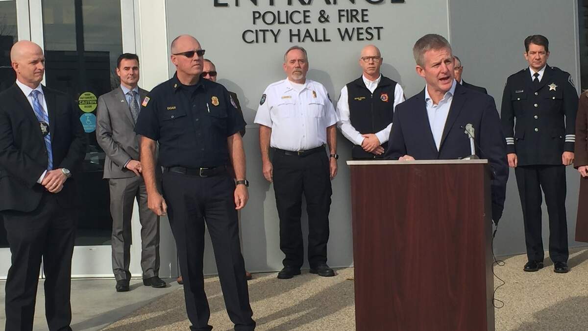 State Rep. Mat Erpelding, D-Boise, spoke Thursday at a lectern outside City Hall West in Boise about his intent to amend Idaho’s Workers’ Compensation fund in 2019 to allow first responders to seek treatment for psychological problems that they sustain in the line of duty. Paul Jagosh, legislative chairman for the Idaho Fraternal Order of Police (far left) and Boise Police Chief Dennis Doan (center) also spoke about the need to amend the law.