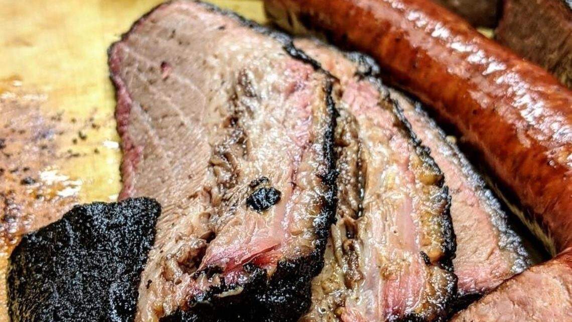 An image of smoked brisket and sausage.