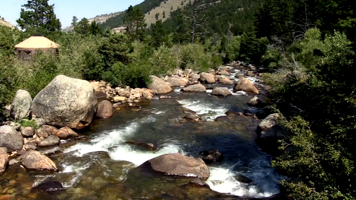 A boy clung to a rock in the middle of a raging river in Wyoming as rescuers rushed to help him.
