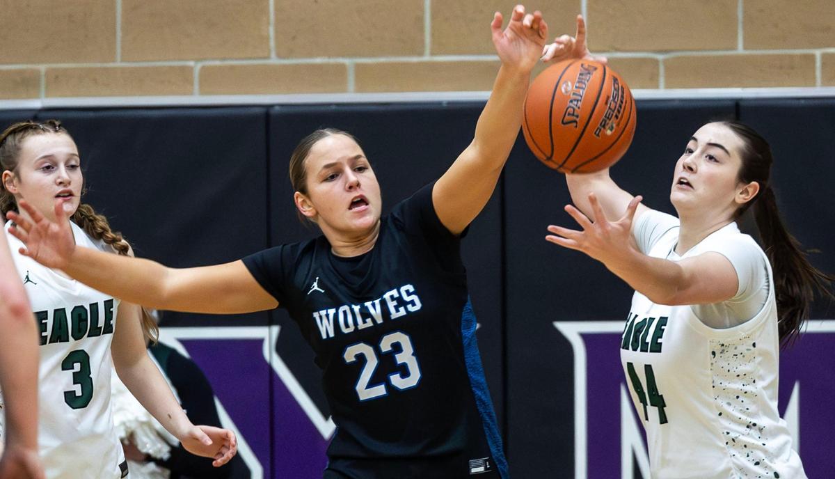 Timberline forward Fanci Sackett battles for a rebound with Eagle’s Porter Wood at last year’s 6A District Three Tournament.