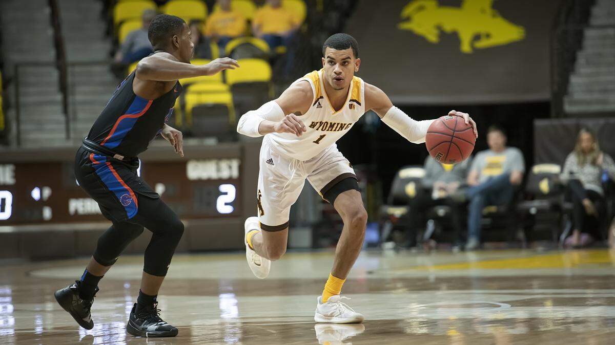 Boise State junior Marcus Dickinson guards Wyoming’s Justin James on Wednesday night in Laramie, Wyoming. The Broncos won 69-55.