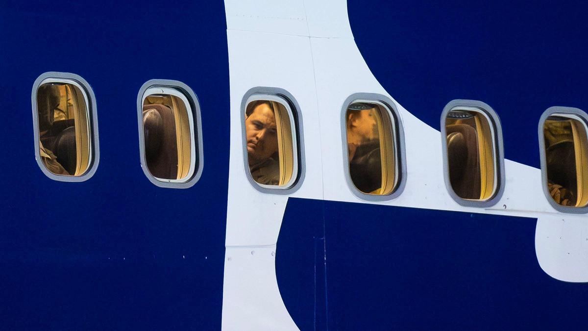 An airman peers out the window of a transport airliner shortly after landing in Boise.