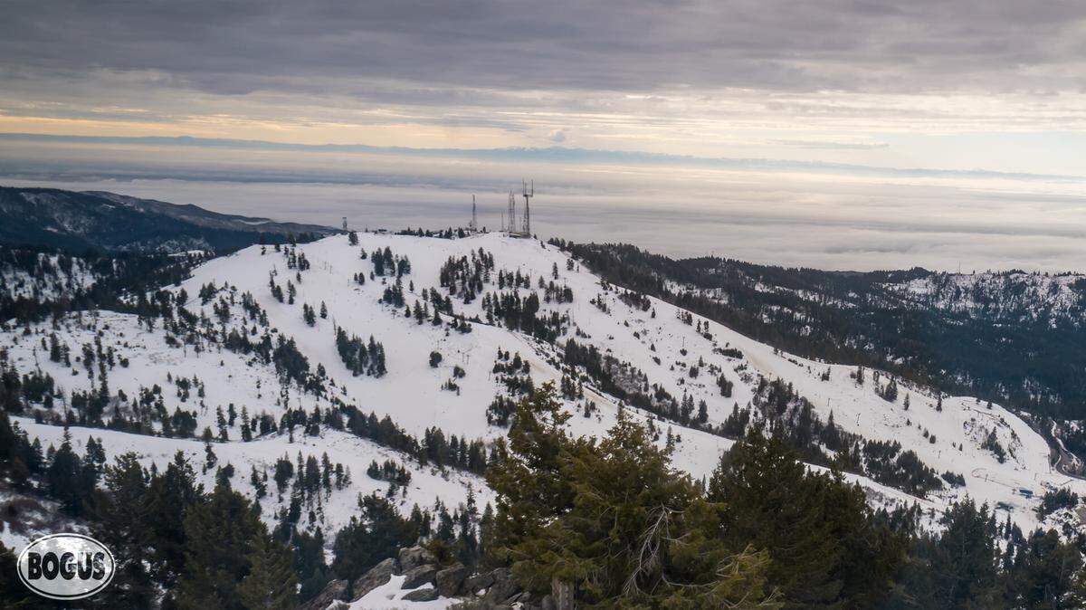 Bogus Basin’s mountain camera shows the slopes – speckled with shrubs and showing signs of wear on some runs – on Friday. Bogus has less snow than usual for this time of year, and it has struggled to make snow due to warm temperatures.