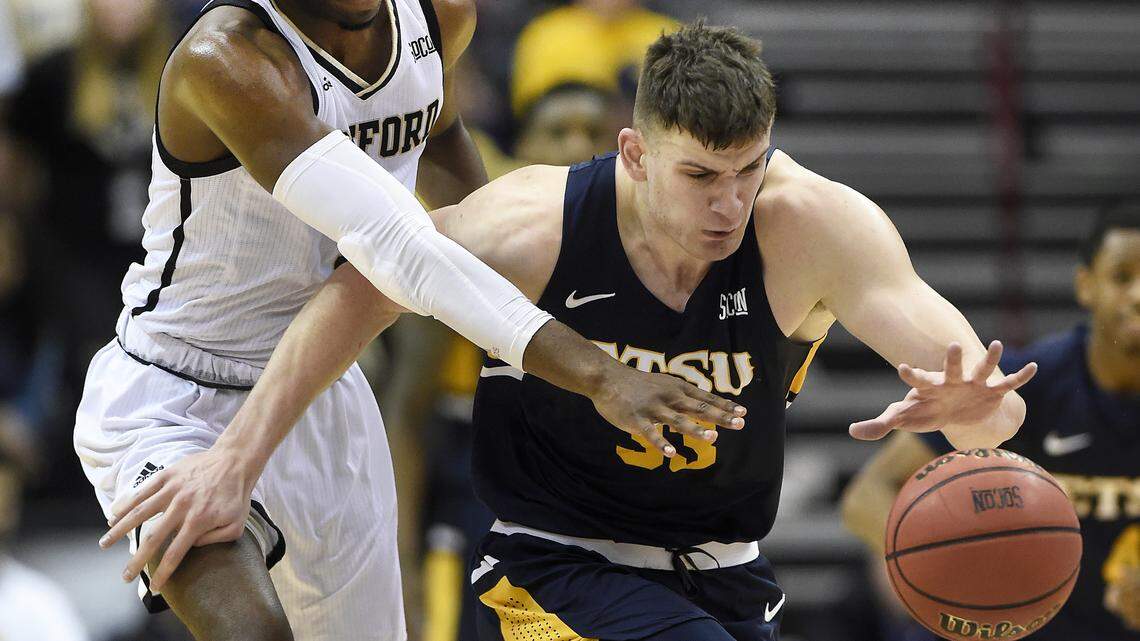 East Tennessee State forward Mladen Armus, right, chases the ball down court ahead of Wofford forward Chevez Goodwin, left, in the second half of their game March 10 in Asheville, N.C. Wofford won 81-72.