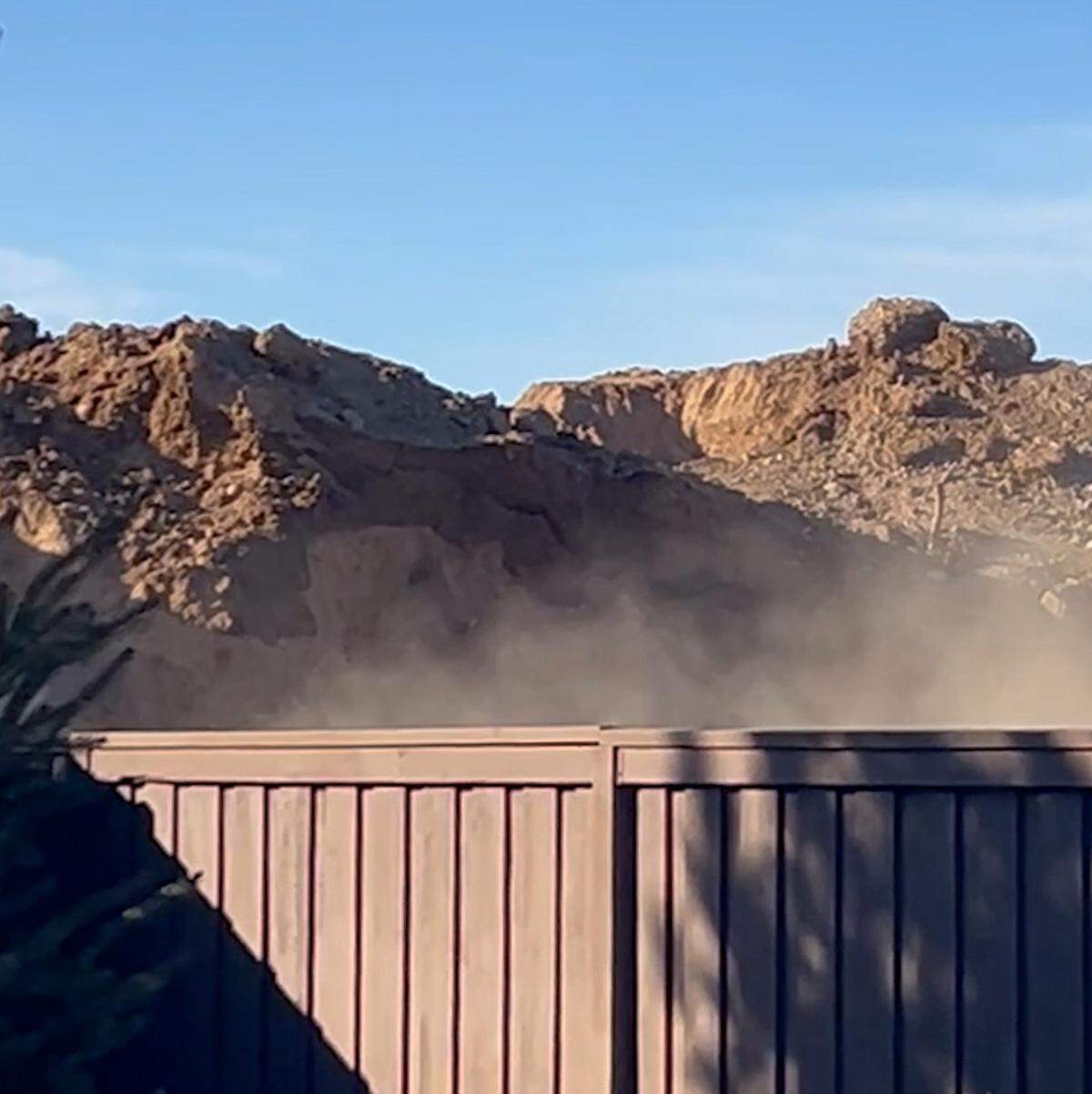 A dirt berm was visible from above a residential fence at the Sagarra construction site in Northwest Meridian.