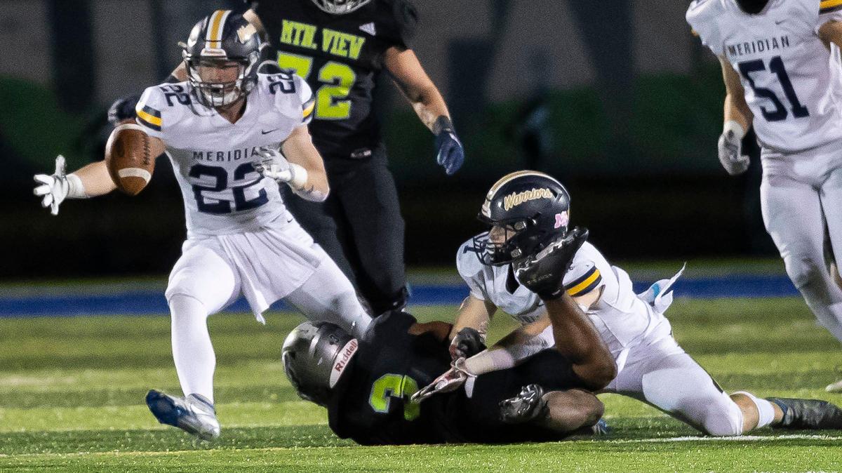 Meridian linebacker Max Gwilliam, left, grabs a fumble during the 5A state quarterfinals last season. Gwilliam is one of nine returning starters on the Warriors’ stout defense.