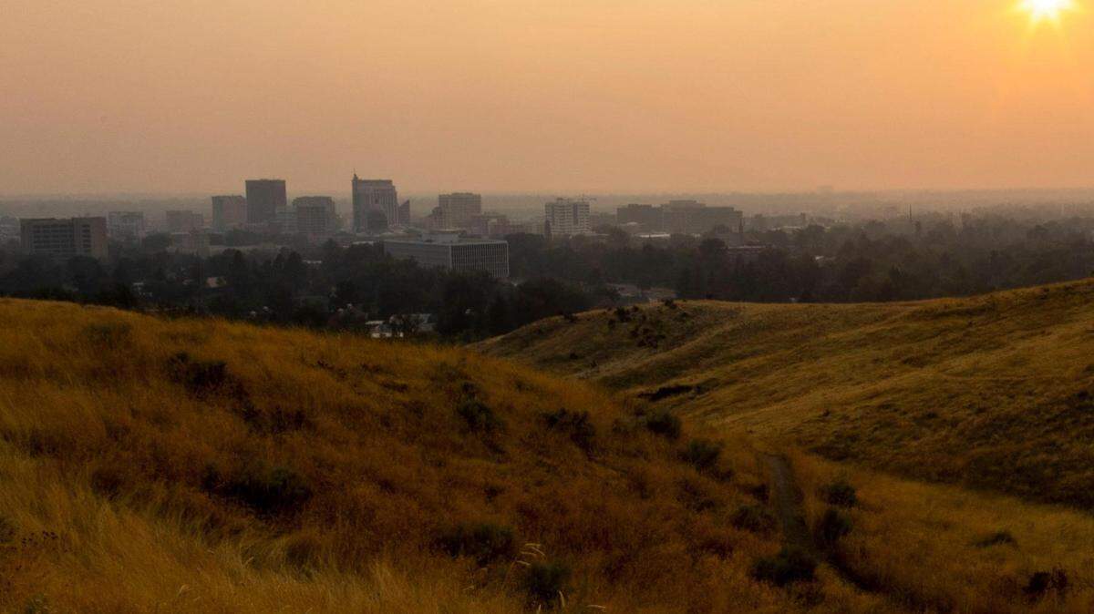 Smoke from regional wildfires glows with an amber hue while lighted by the setting sun over Boise last September. Prescribed burns are taking place in the Boise National Forest to try to reduce wildfire threats this year.