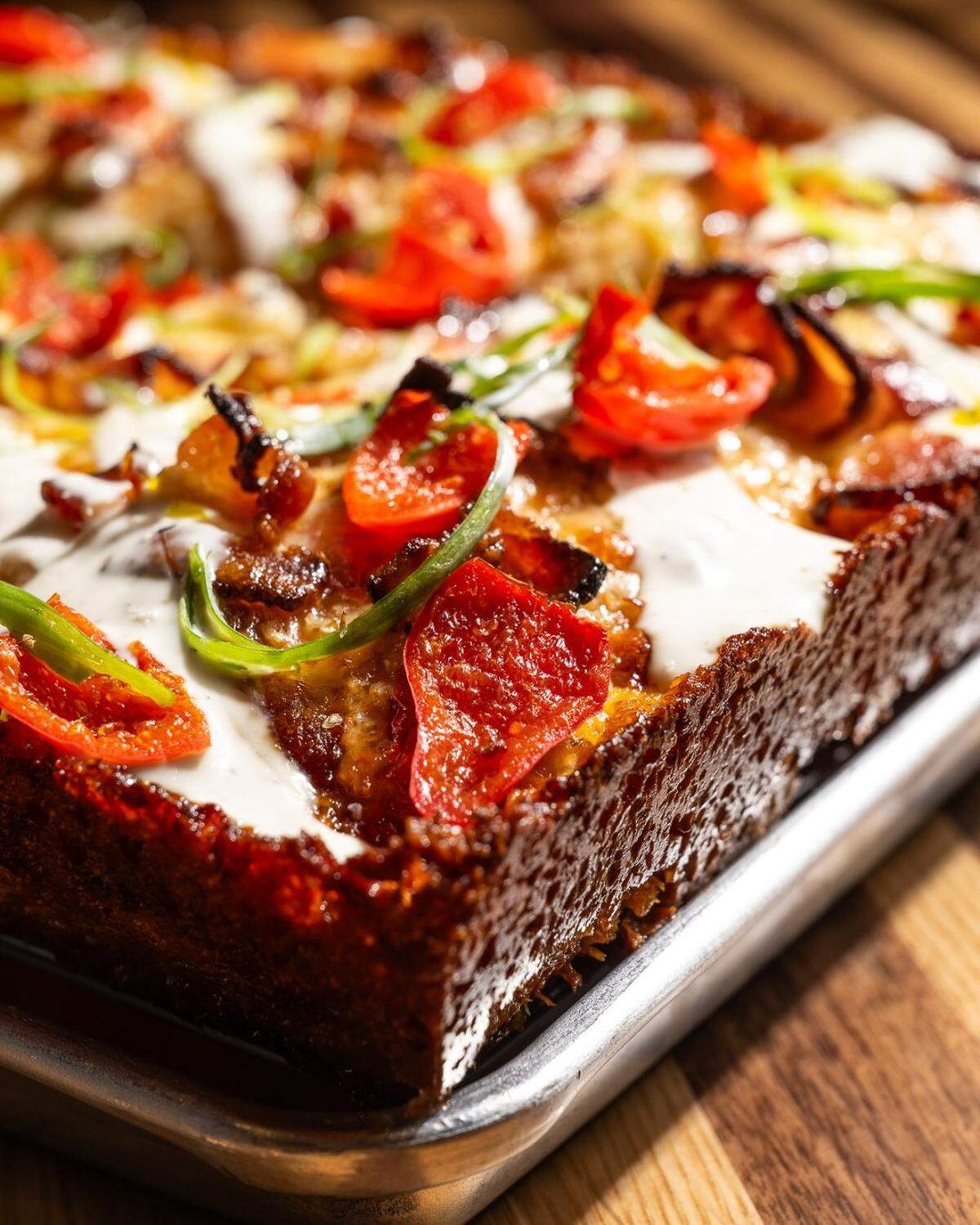 “Crispy on the outside, fluffy on the inside, and absolutely loaded — say hello to our Tony Jack Detroit!” Slice House wrote on social media. “With golden edges and a buttery crunch under layers of melted mozzarella, drizzles of ranch, and a topping spree of smoked bacon, Peppadew peppers, and a hint of honey, every bite hits the spot.”
