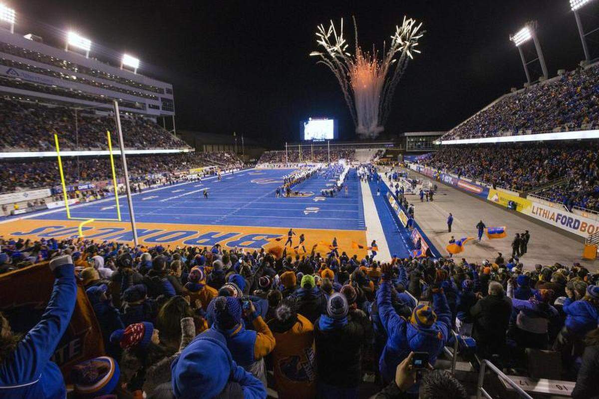 Boise State fans welcome the Broncos onto the field in a game last November against Utah State.