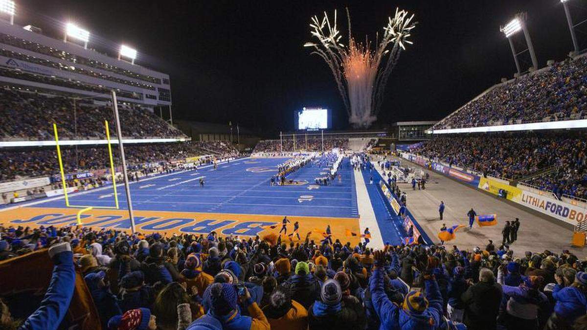 Boise State fans welcome the Broncos onto the field in a game last November against Utah State.