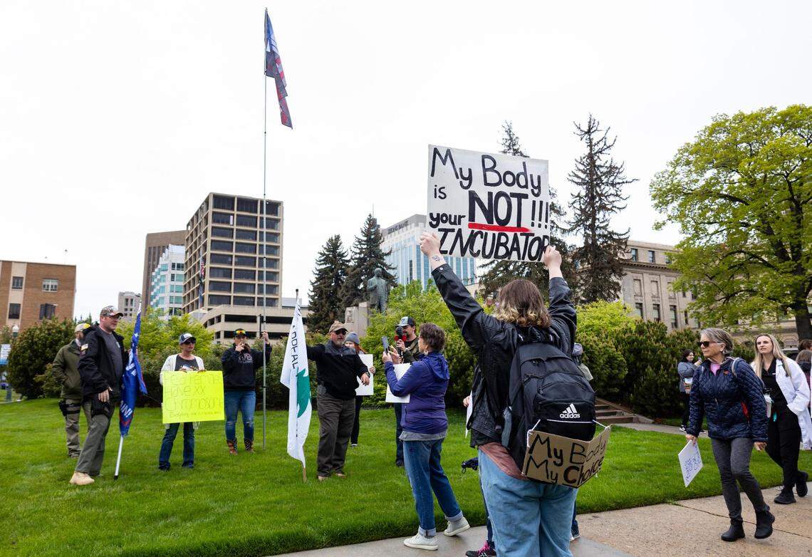 Boise resident Ashlee Worle faces a small group of counter-protesters with her “My body is not your incubator” sign before the start of Planned Parenthood’s Bans Off Our Bodies rally for abortion rights outside of the Idaho Statehouse in downtown Boise on Saturday.