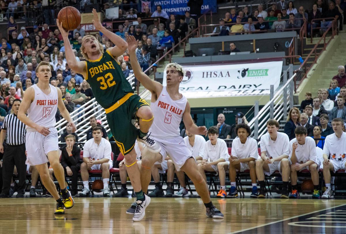 Borah senior Austin Bolt drives by Post Falls’ Zackary Rodriguez in the 5A state boy’s basketball championship Saturday, March 7, 2020 at Ford Idaho Center in Nampa.