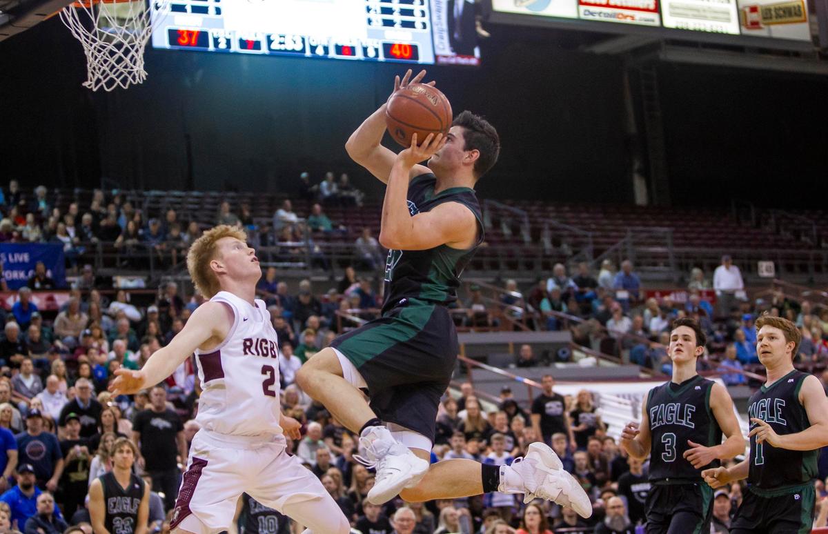 Eagle senior Jordan Kemp stole the ball and finished a layup over Rigby’s Kaden Miller in the fourth quarter of the Mustangs 51-43 uspet of Rigby.