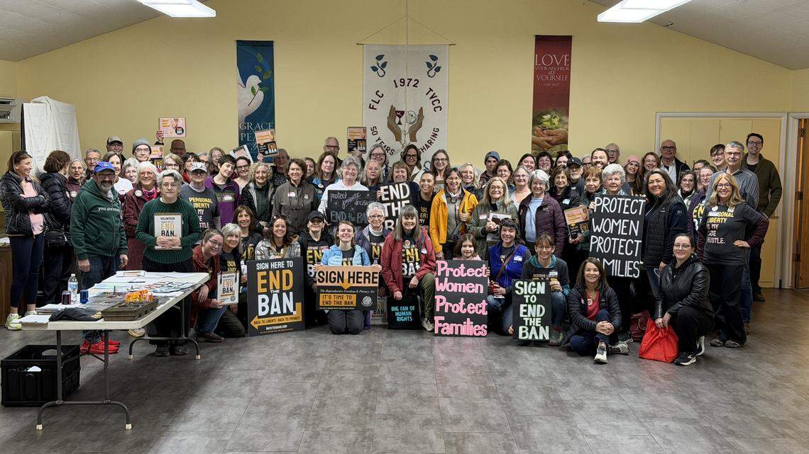Idahoans United for Women and Families supporters pose with signs bearing slogans urging an end to Idaho’s abortion ban. The group is behind the ballot initiative that would carve out the right to abortion until fetal viability, as well as rights to contraception, fertility treatment and other reproductive health care.