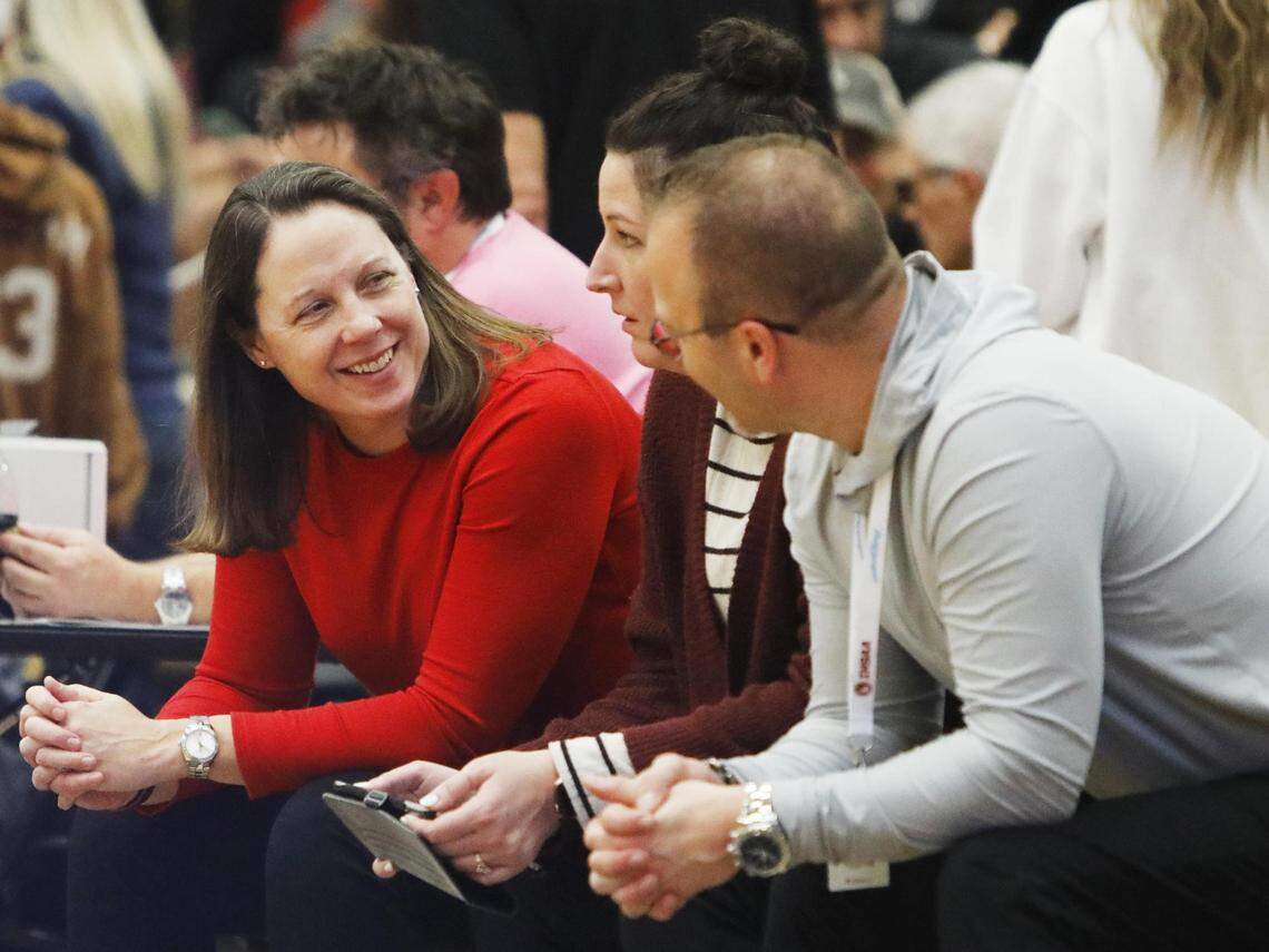Boise girls basketball coach Kim Brydges, left, announced her retirement from coaching last week. Above, she shares a laugh with her assistant coaches before the state tournament third-place game in 2024 at Bishop Kelly.