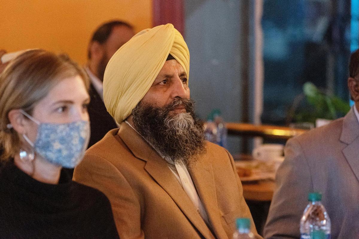 Mehar Singh, owner of Boise restaurant Bombay Grill, sits with gusts as he listens to his daughter Simran Kaur address the room during a special event for Sikh Awareness and Appreciation Month at the restaurant.
