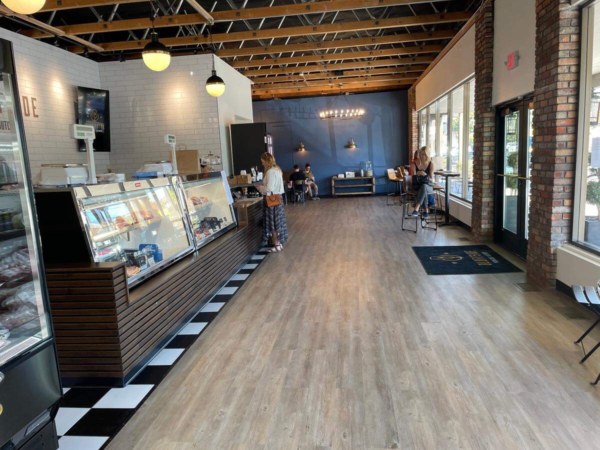 Bluffside’s main deli space is flanked by a dining area with tables around the corner on one side, and a wine and beer display room on the other.