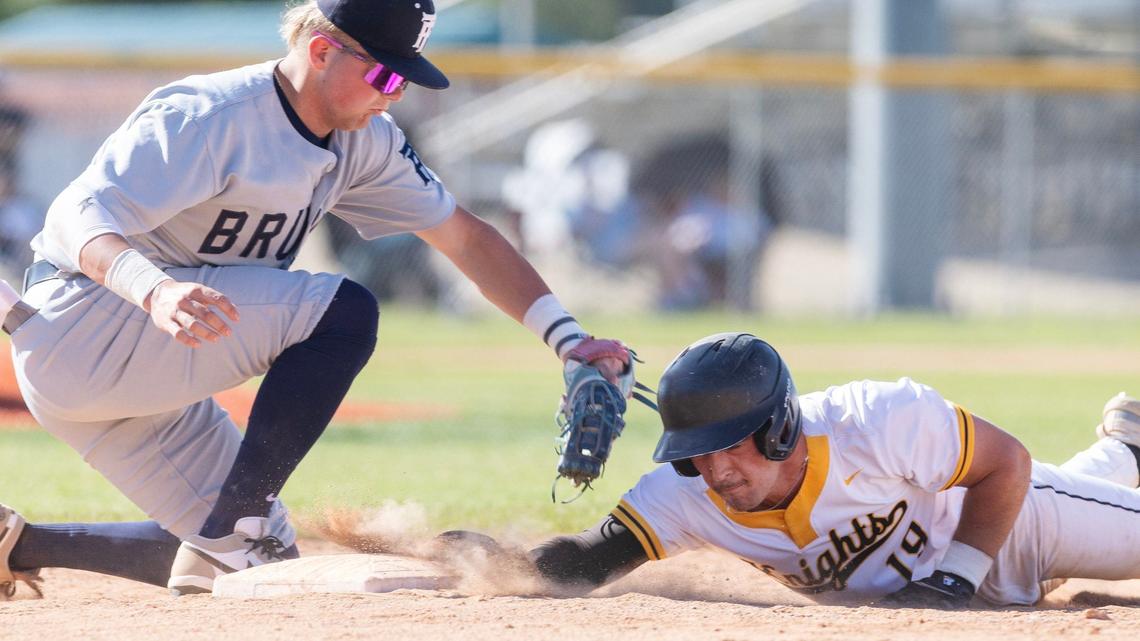 Bishop Kelly’s Gianni Caltagirone is safe back at first base before Twin Falls’ Cooper Thompson can tag him during a 4A state tournament game held Thursday at Vallivue High.