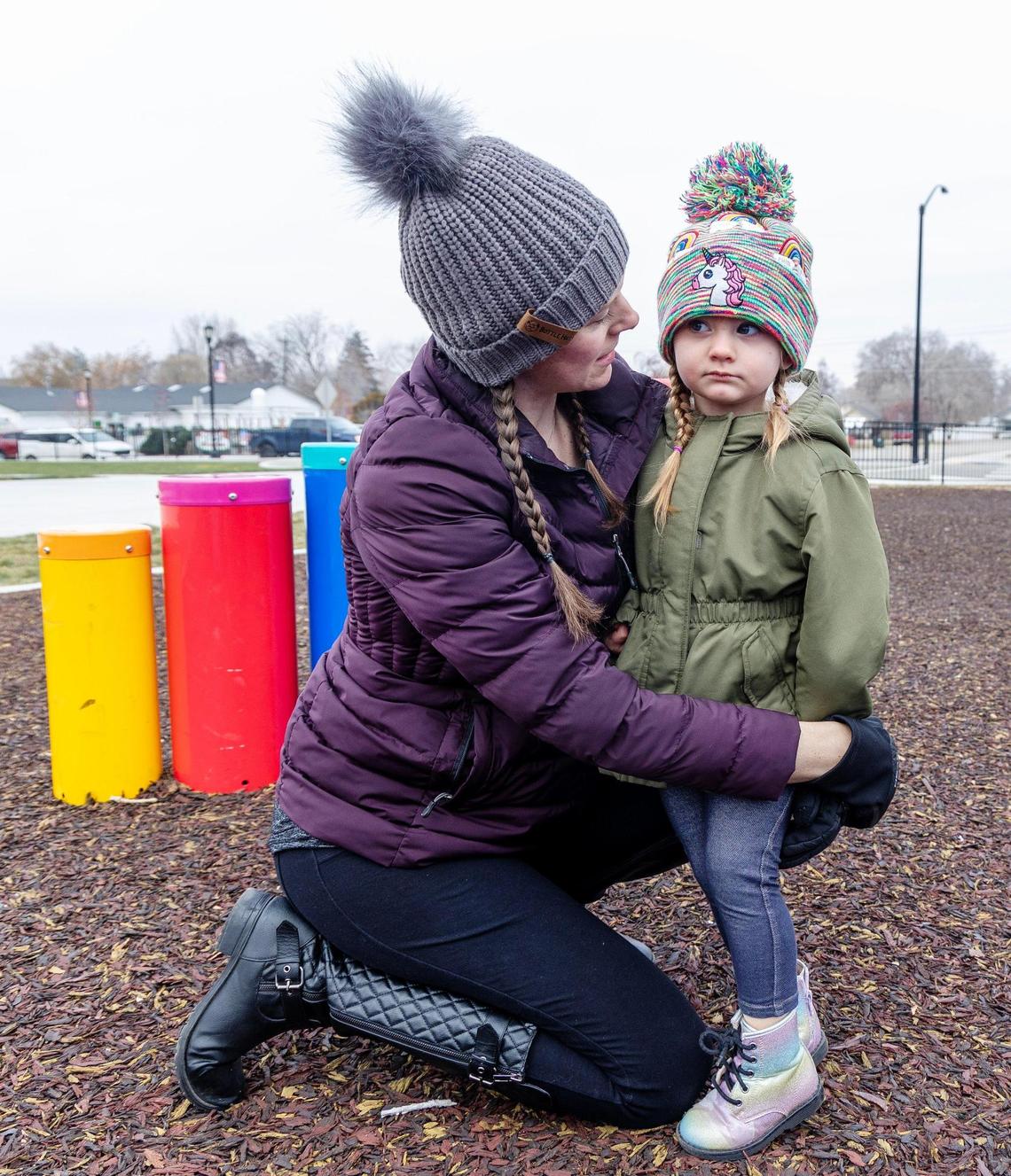 Rebecca Vincen-Brown comforts her daughter Winter, 2, on the playground at Bernie Fisher Park in Kuna.