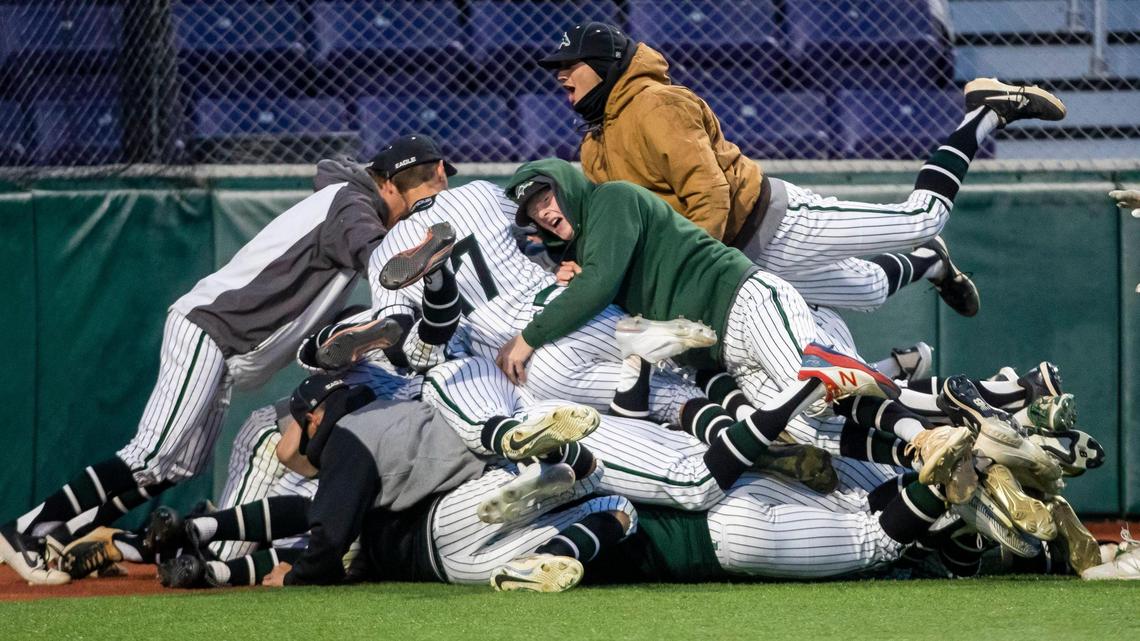 Eagle dog piles onto senior Ethan Wolff after scoring the winning run on a wild pitch to beat Rocky Mountain 4-3 in the bottom of the eighth inning Friday at Wolfe Field in Caldwell. The Mustangs will face Timberline in the 5A state championship Saturday.