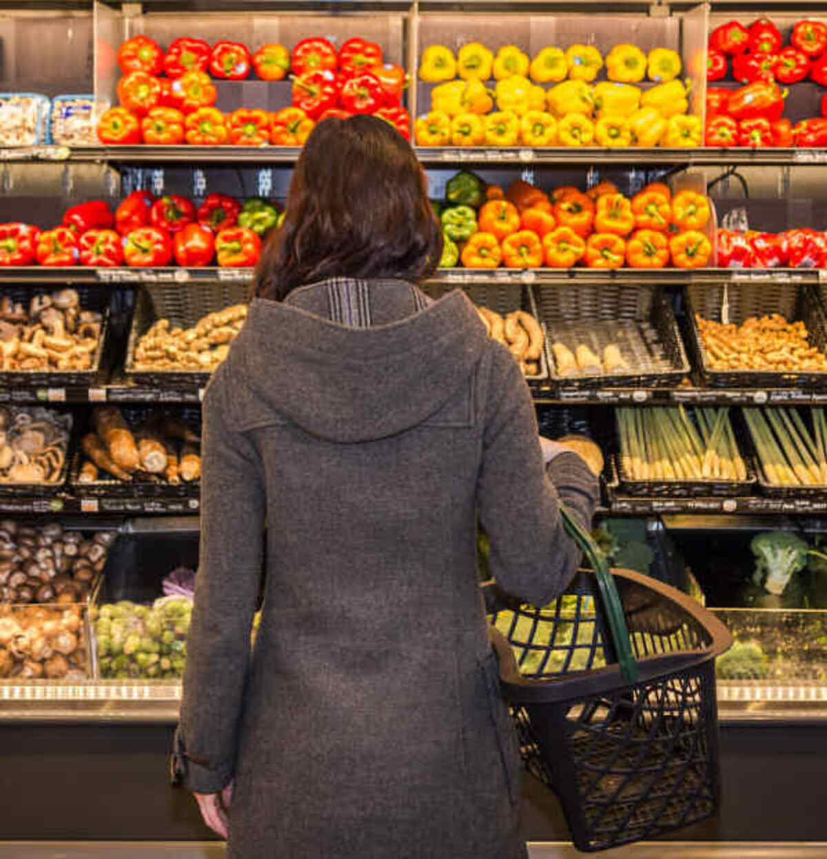 A shopper is shown looking through a fresh produce section in this 2022 file photo. Cyclospora parasites are known to contaminate fresh produce like raspberries and lettuce.