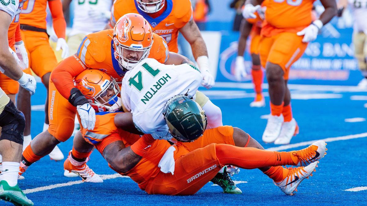 Boise State linebacker Ezekiel Noa and defensive lineman Cortez Hogans Jr. take down Colorado State wide receiver Tory Horton during the Broncos’ 49-10 win over Colorado State.