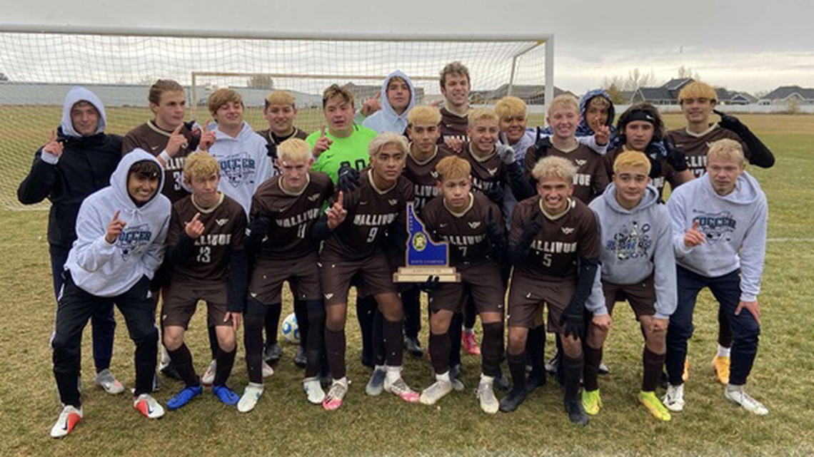 The Vallivue High School boys soccer team poses with the first state championship trophy in program history after the Falcons beat Blackfoot 4-1 on Saturday at Bonneville High School in Idaho Falls..