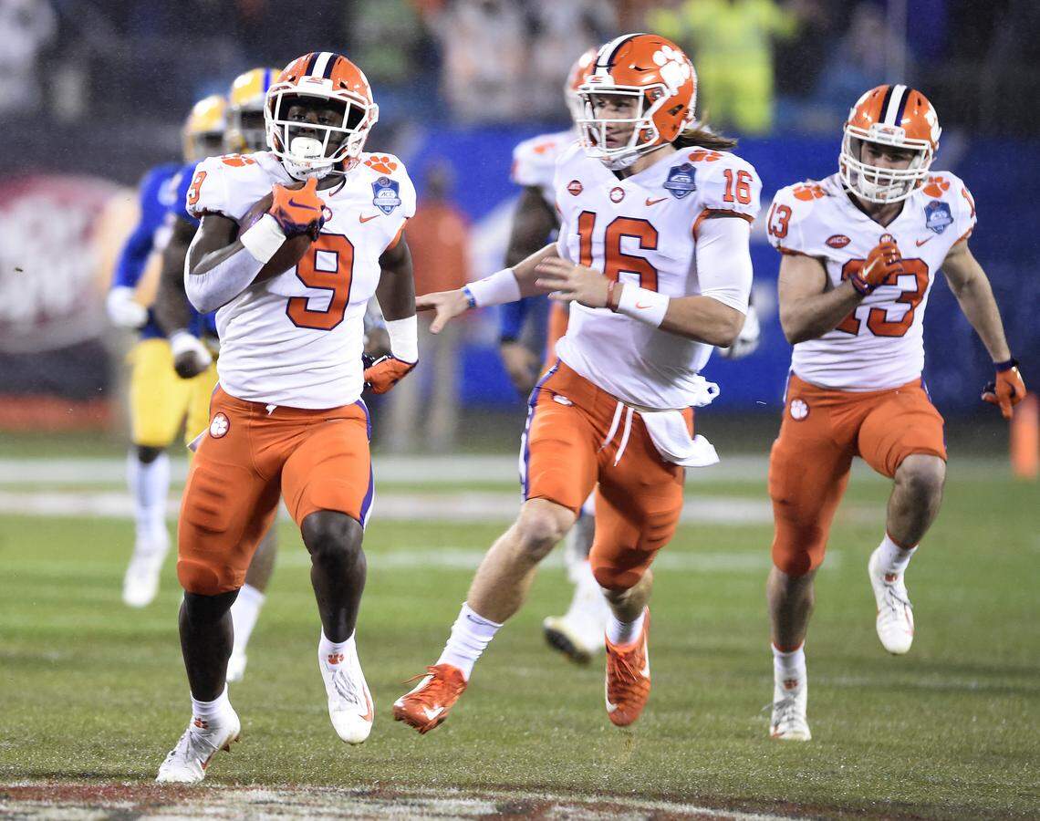 FILE - In this Saturday, Dec. 1, 2018, file photo, Clemson’s Travis Etienne (9) followed by quarterback Trevor Lawrence (16) runs for a touchdown against Pittsburgh in the first half of the Atlantic Coast Conference championship NCAA college football game in Charlotte, N.C. Clemson’s high-octane offense is led by the pair of young, talented offensive players. (AP Photo/Mike McCarn, File)