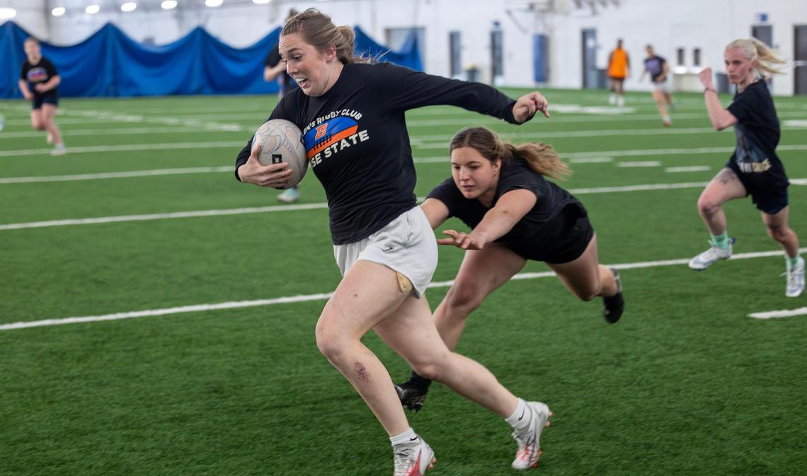 Ella Ogletree evades a tackle attempt by teammate Briana Fry during a Boise State women’s rugby practice at Caven-Williams Sports Complex in Boise.
