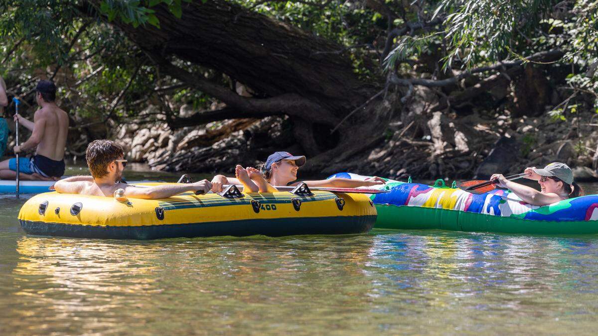 People float and cool off in the Boise River in July 2023.