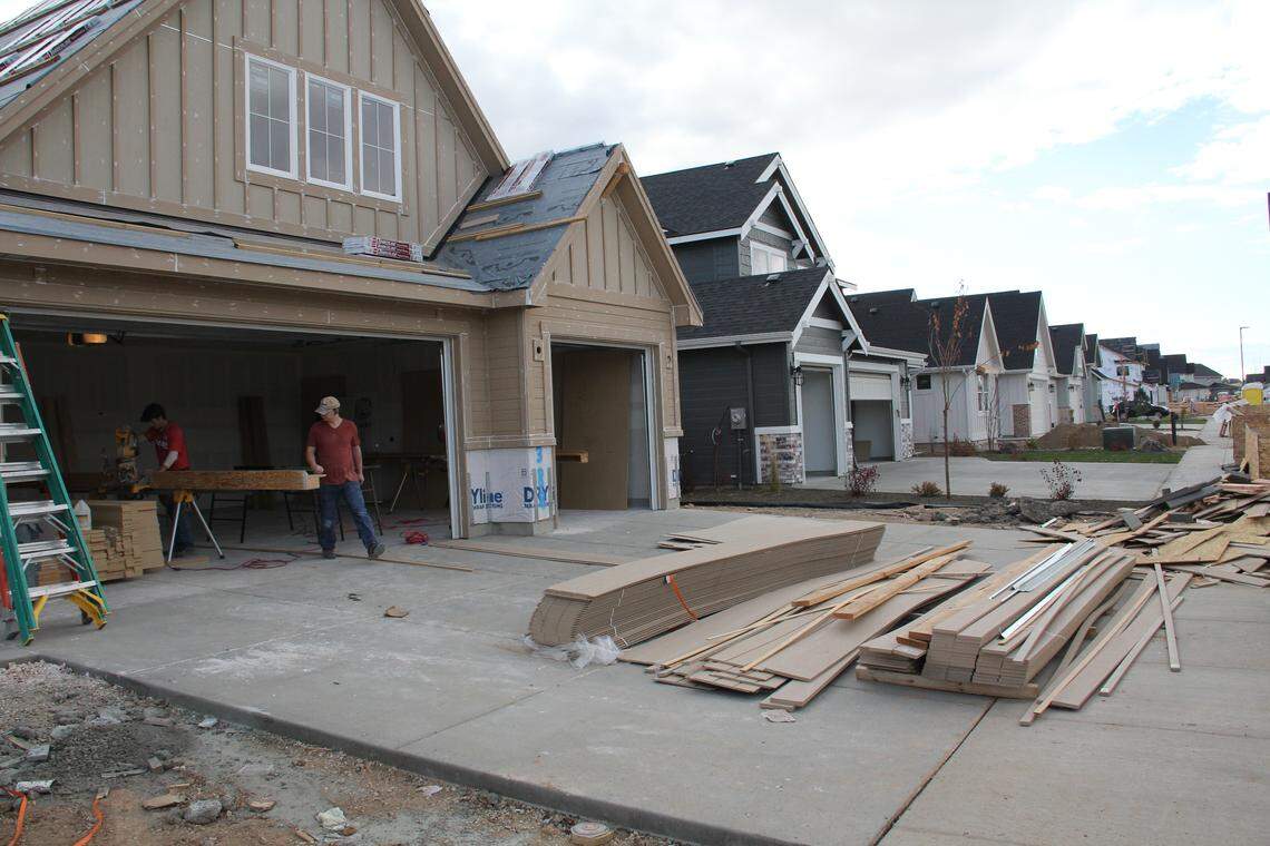 At the Century Farms subdivision in Meridian, construction workers build a new home. Meridian has exploded with growth in the last several years. The city raised impact fees in March, forcing developers to pitch in more to capital improvement projects.