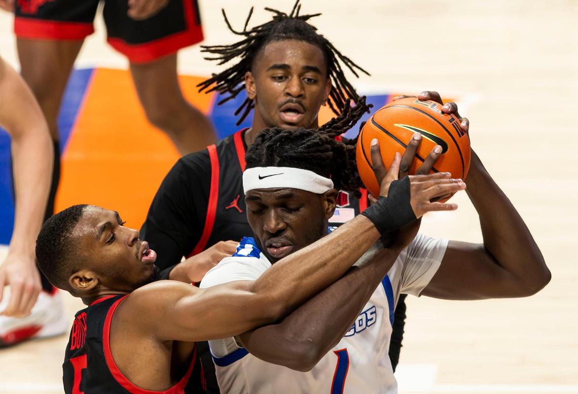 Boise State guard O’Mar Stanley works for position defended by San Diego State guards Lamont Butler (left) and Reese Waters on Saturday at ExtraMile Arena.