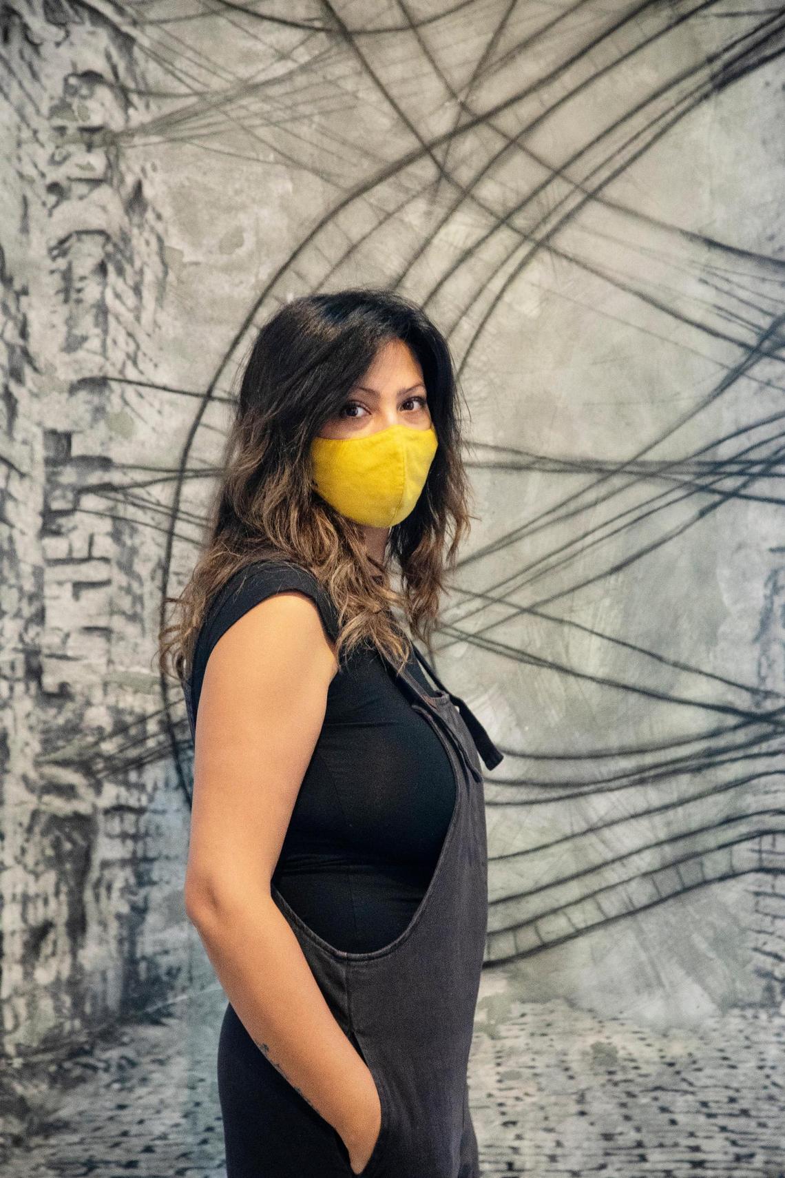 Iraqi-born artist Luma Jasim is pictured with her work in the exhibit Long Term Vision, open from Aug. 22 to Oct. 3 at Boise State’s Student Union Building Fine Arts Gallery.