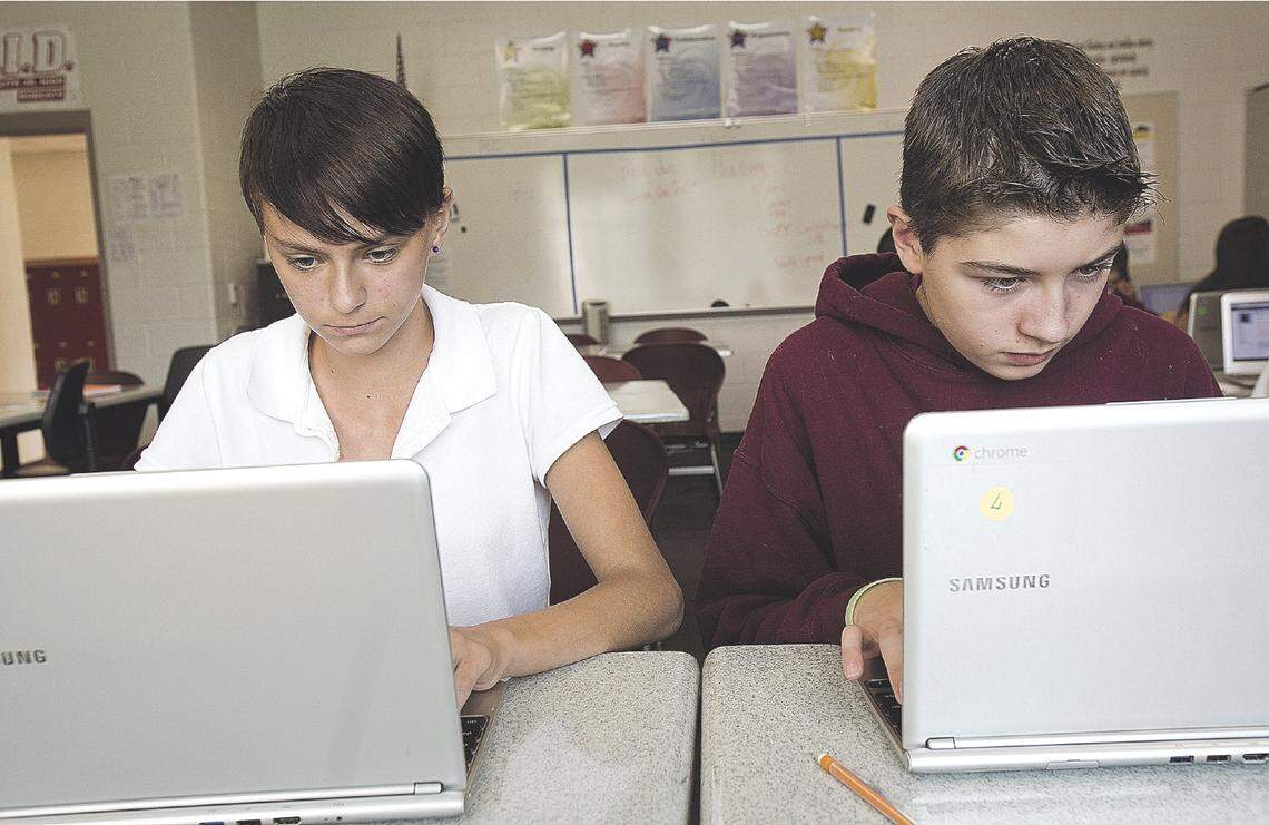 Tess Coe and Kaleb Madenford of South Junior High School work with Google Apps for Education in 2014. The Boise School District is offering an online-only school for students this fall during the coronavirus pandemic.