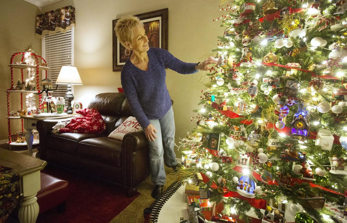 Nikki puts a finishing touch on the Gridley’s living room tree that is loaded with nearly 500 interactive ornaments.