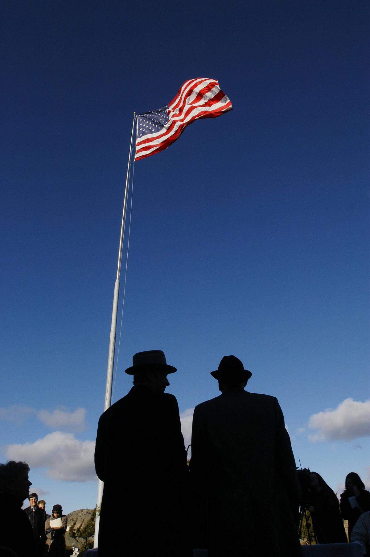J.R. Simplot, right, and then-Gov. Dirk Kempthorne on the day in 2004 when Simplot gave the house and its iconic flag to the state of Idaho.