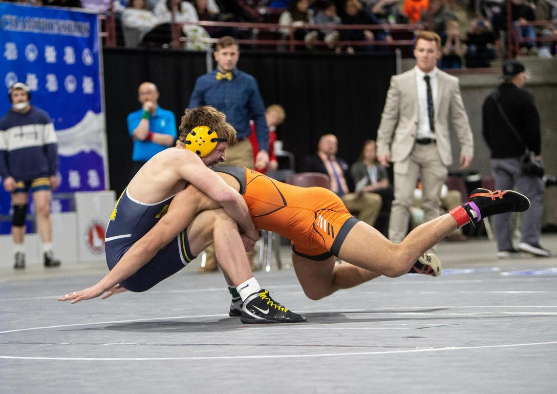 Hudson Rogers of Meridian, left, and Jose Laguna of Post Falls compete in the 5A 170-pound state final held at the Ford Idaho Center last season.