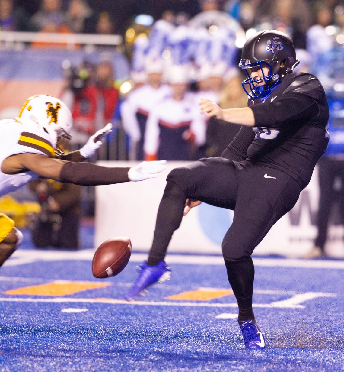 Boise State kicker Joel Velazquez (46) gets off a punt under heavy pressure from the Wyoming defense during the game at Albertsons Stadium in Boise, Idaho. Boise State defeated Wyoming 20-17 in overtime. Kyle Green For The Idaho Statesman Saturday November, 09, 2019.