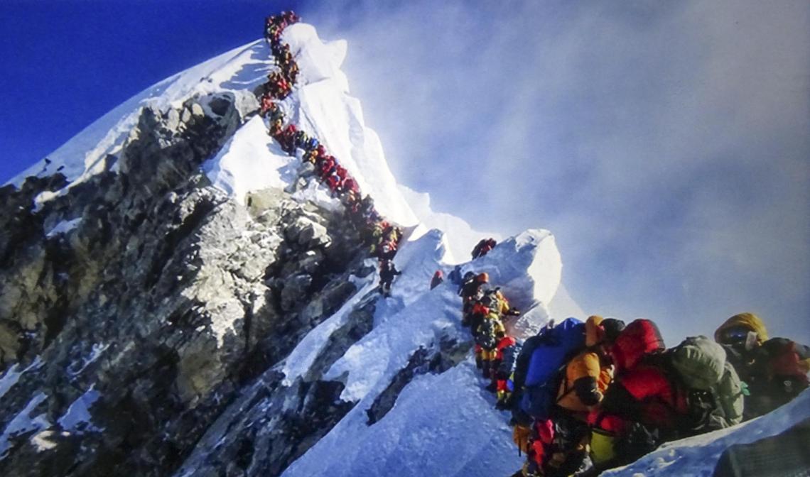 Ang Dorjee Sherpa and his team navigate the Hillary step in a long line of climbers attempting Everest on May 22, 2019. Poor weather and a narrow window of opportunity created a congested climb to the summit.