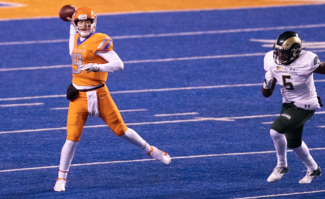 Boise State quarterback Hank Bachmeier (19) throws a pass while being pursued by Colorado State linebacker Dequan Jackson (5) during the game against Colorado State University at Albertsons Stadium. Boise State defeated CSU 52-21 Thursday, Nov. 12, 2020.