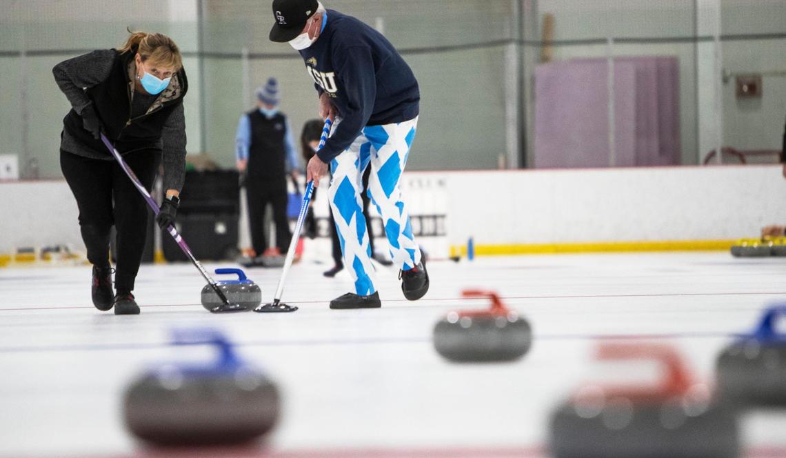 Jill and Scott Muir sweep in front of moving stone, making it curl on a path of less resistance in a targeted direction. The husband and wife were competing with their team, Cleaning House, in a Boise Curling Club championship game at IceWorld in Boise Sunday.