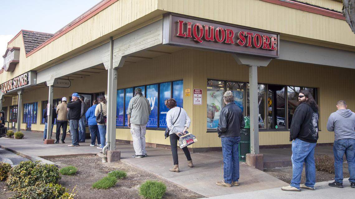 Patrons lined the sidewalk in front of the liquor store at 17th and State streets in 2020 after Gov. Brad Little ordered Idahoans to stay at home except for essential business.