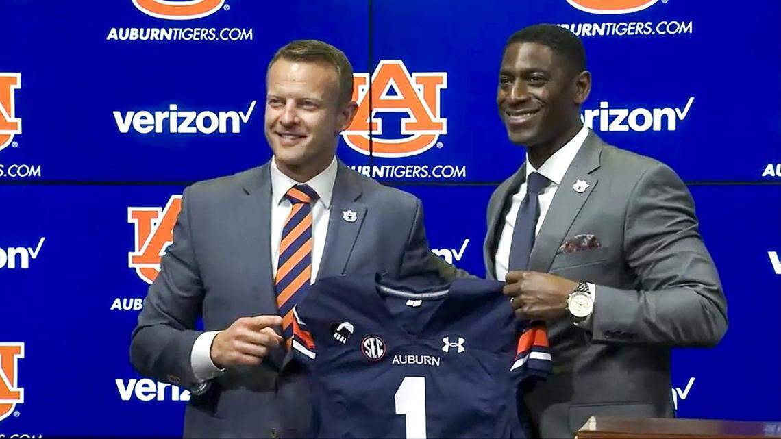 Former Boise State coach Bryan Harsin holds an Auburn football jersey with Athletic Director Allen Greene during a press conference welcoming Harsin as the Tigers’ new head football coach on Dec. 24 at Auburn.