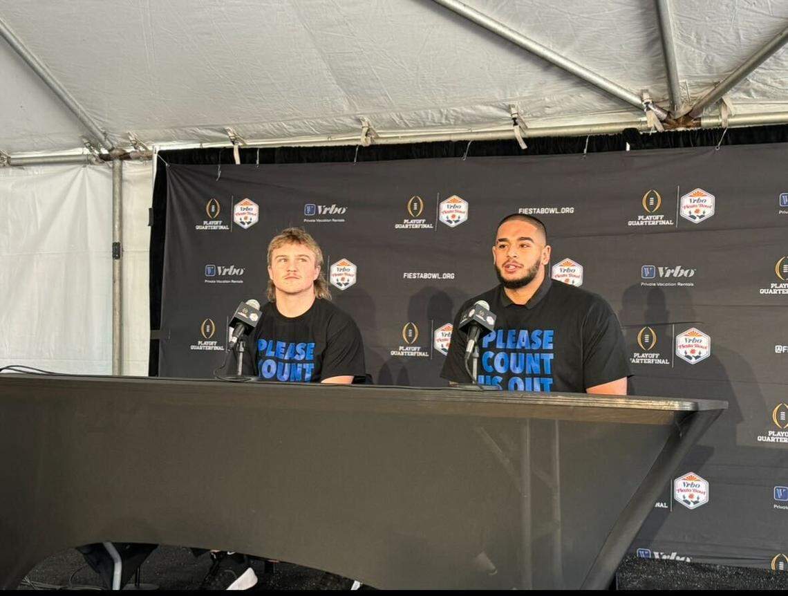 Maddux Madsen and Ahmed Hassanein wear the “Please count us out” t-shirts that has become popular with the program heading into the Fiesta Bowl.