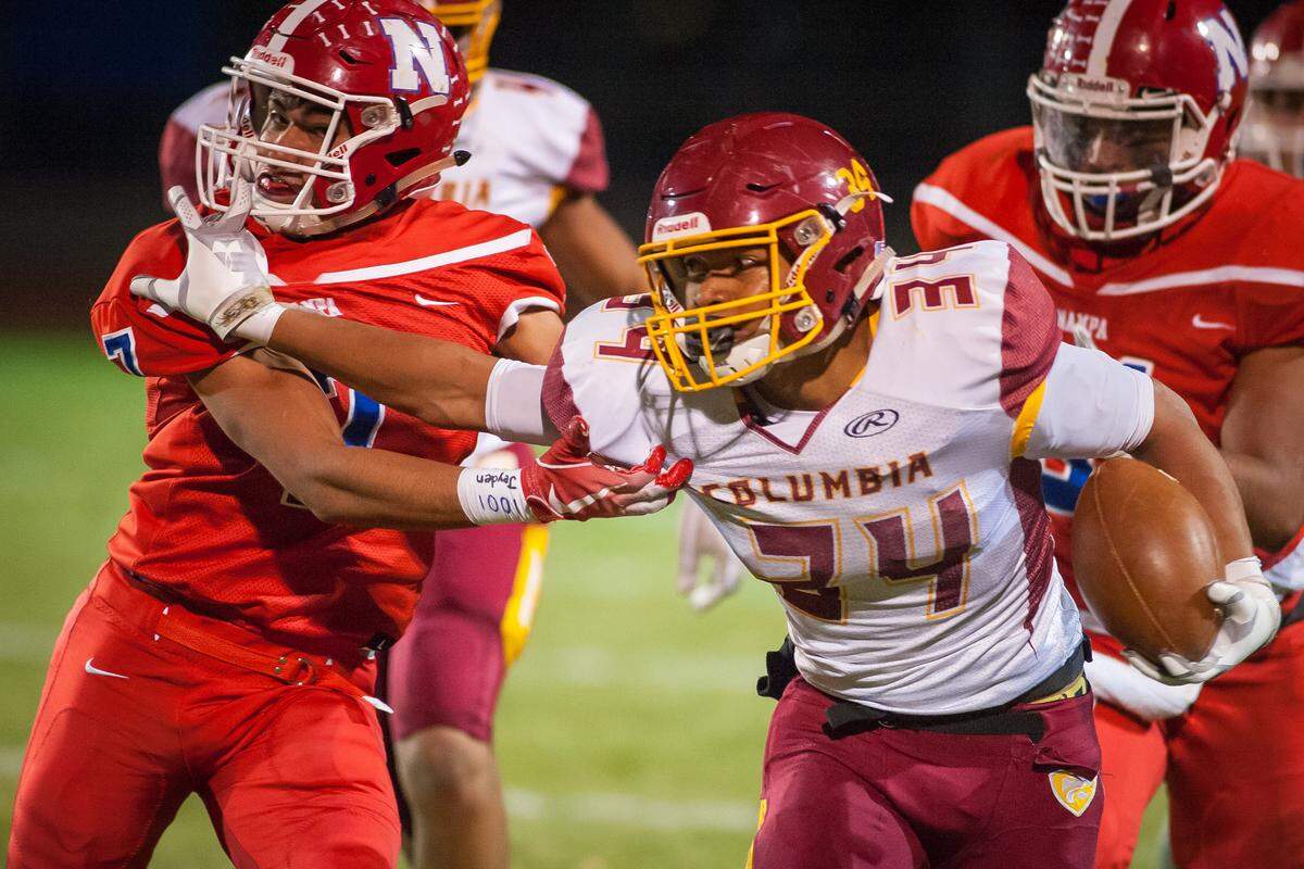 Columbia running back Allamar Alexander fights off a Nampa tackler Nov. 2 at Nampa High in the 4A state quarterfinals.