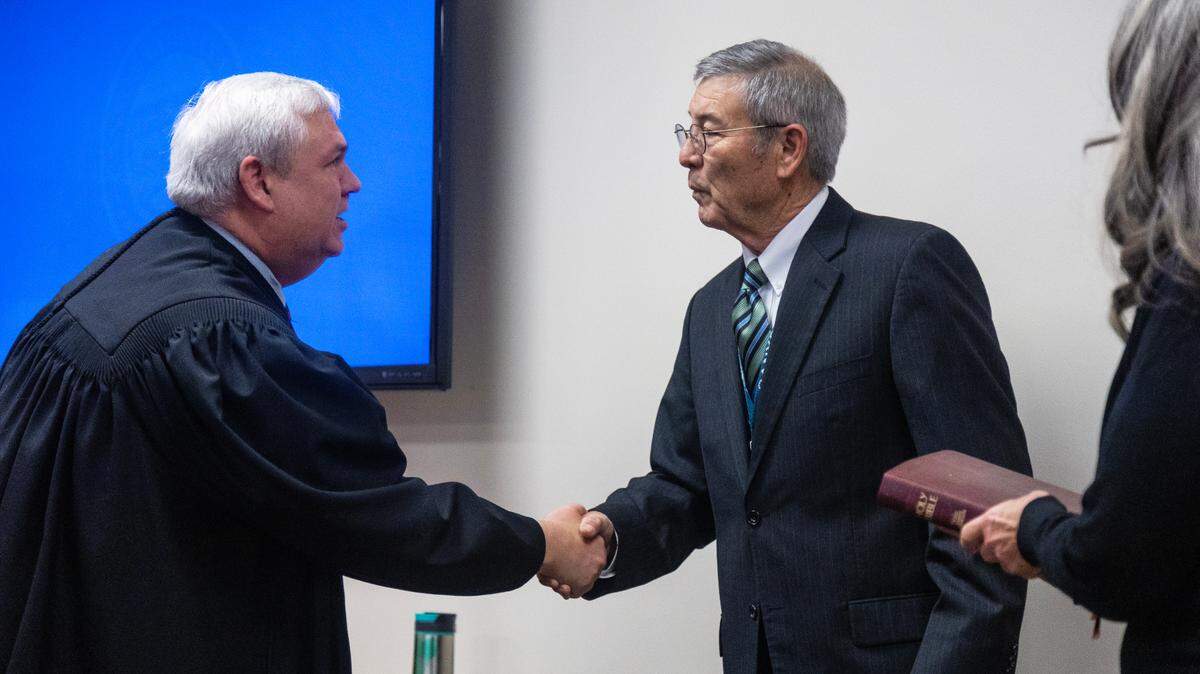 District Judge Davis VanderVelde, left, shakes hands with Canyon County Clerk Chris Yamamoto. Yamamoto resigned from his clerk position in January in a letter to the county commissioners and residents.